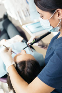 dentists with a patient during a dental interventi XTGQEFJ