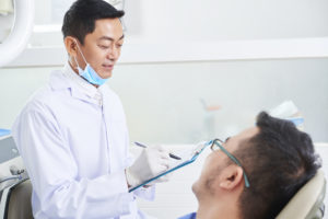 asian male dentist at work D9DE6XX 1
