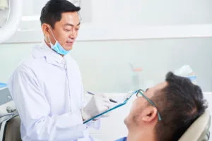 asian male dentist at work D9DE6XX 1