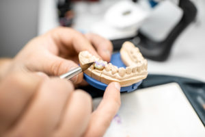 dental technician coloring dental prosthesis G5VQCY5