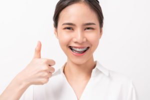 smiling asian woman and showing thumbs up or like 2021 09 01 18 14 37 utc 1