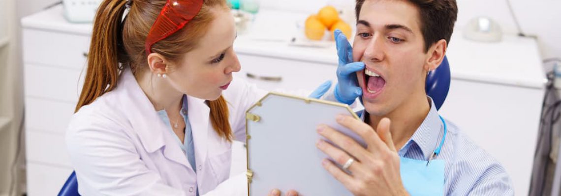 female-dentist-showing-teeth-to-patient-2022-01-20-19-45-51-utc (1)