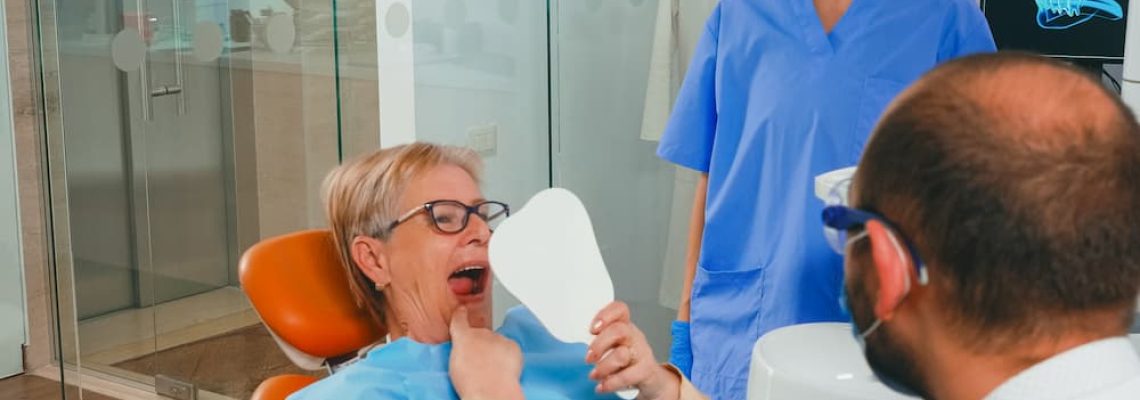 woman-with-new-dental-implants-looking-in-the-mirr-2021-08-29-16-24-18-utc (1)
